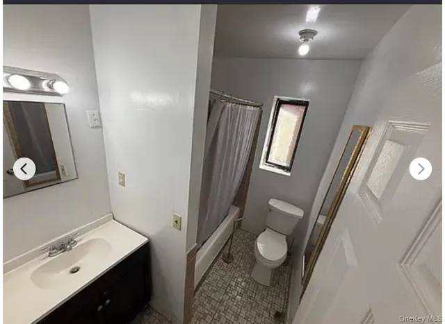 a bathroom with a sink a toilet and mirror