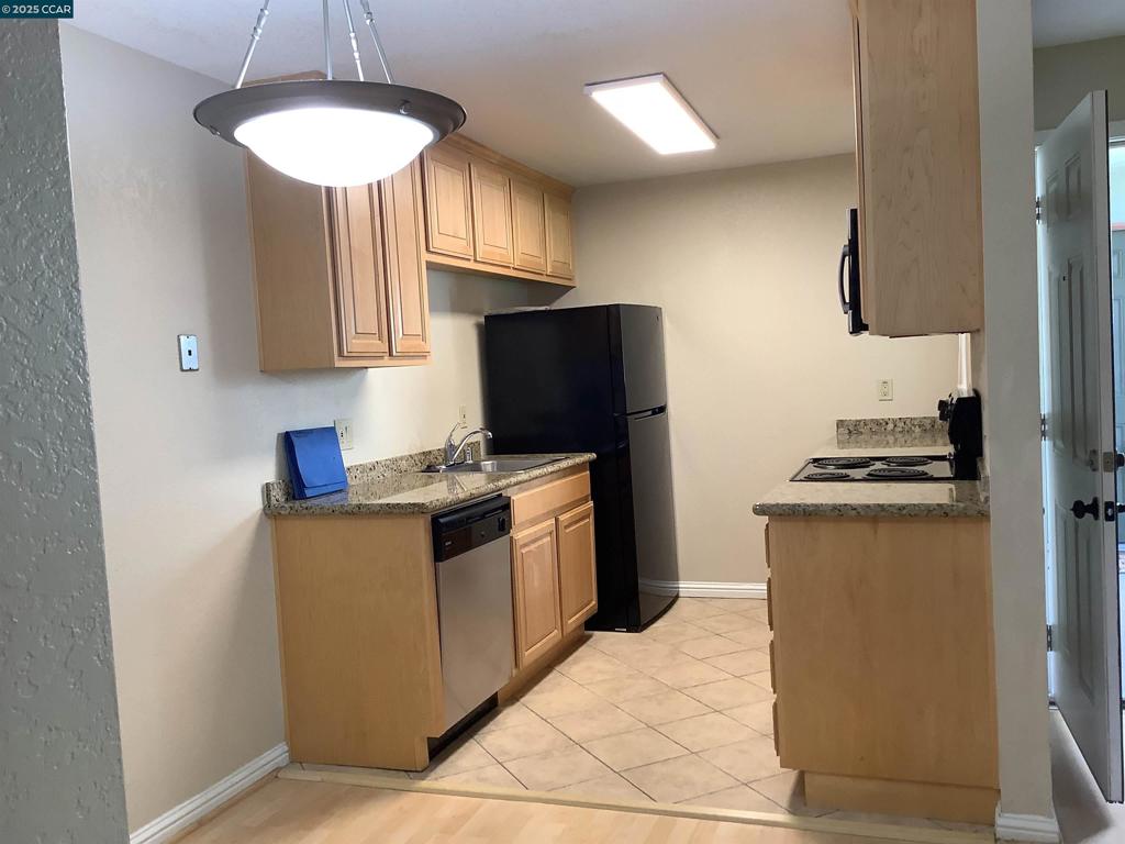 1505 Kirker Pass Road Concord, CA 94521 - Photo 15 of 19 a kitchen with stainless steel appliances granite countertop a stove a refrigerator and a sink