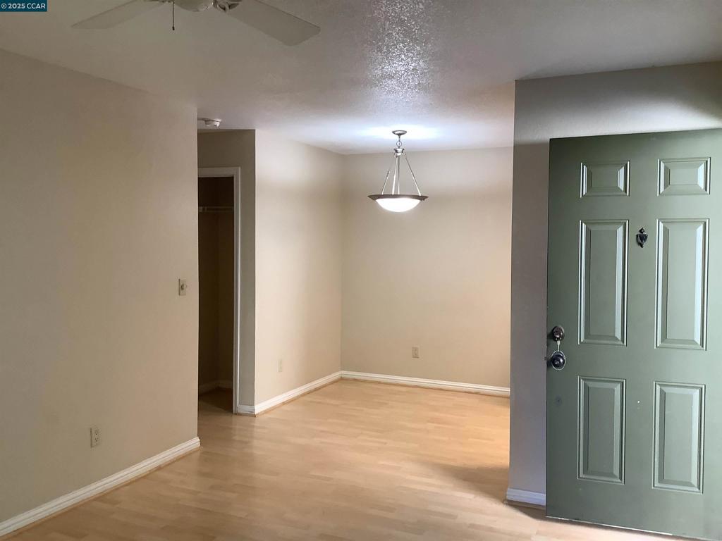 1505 Kirker Pass Road Concord, CA 94521 - Photo 5 of 19 an empty room with fan and mirror