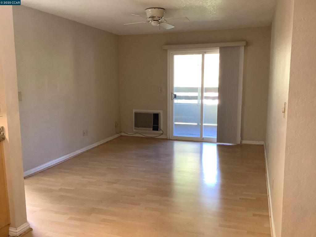 1505 Kirker Pass Road Concord, CA 94521 - Photo 6 of 19 a view of empty room with wooden floor and fan