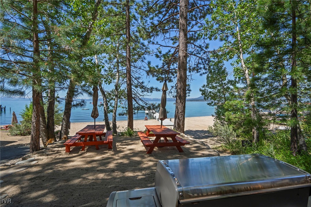 1585 Pine Cone Circle Incline Village, NV 89451 - Photo 11 of 24 a view of a backyard with table and chairs and a large tree