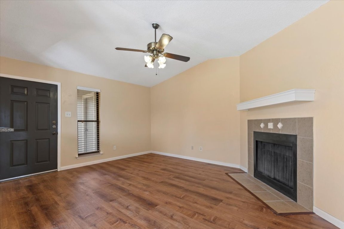 10616 Mellow Meadow Drive, Unit 21C Austin, TX 78750 - Photo 11 of 39 a view of empty room with wooden floor and fireplace