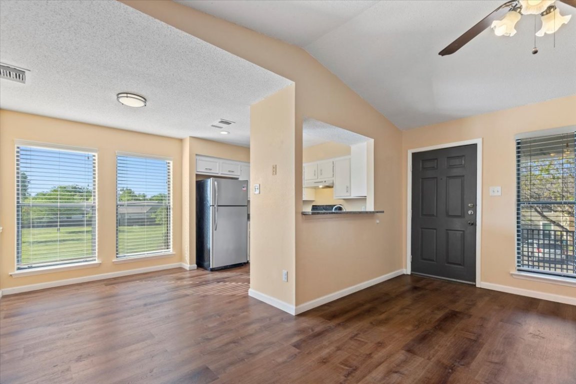 10616 Mellow Meadow Drive, Unit 21C Austin, TX 78750 - Photo 13 of 39 a view of an empty room with a window and wooden floor