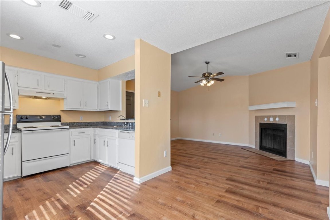 10616 Mellow Meadow Drive, Unit 21C Austin, TX 78750 - Photo 14 of 39 a kitchen with a sink and a stove