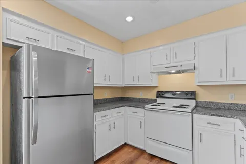 a view of a livingroom with an empty space and a window