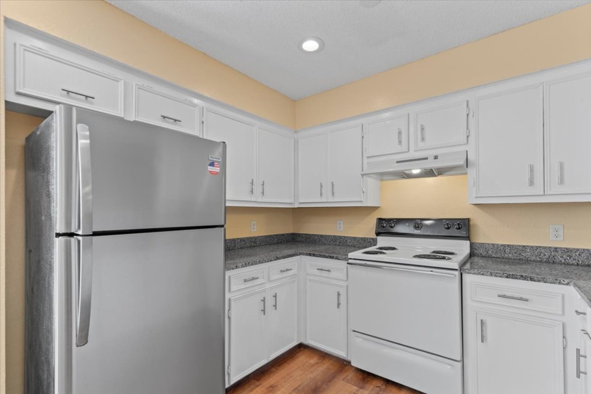10616 Mellow Meadow Drive, Unit 21C Austin, TX 78750 - Photo 17 of 39 a kitchen with refrigerator a stove a sink and cabinets
