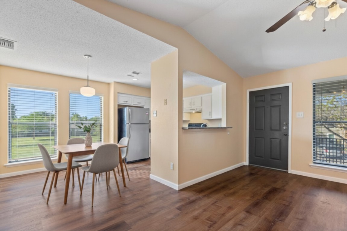 10616 Mellow Meadow Drive, Unit 21C Austin, TX 78750 - Photo 2 of 39 a view of a dining room with furniture window and wooden floor