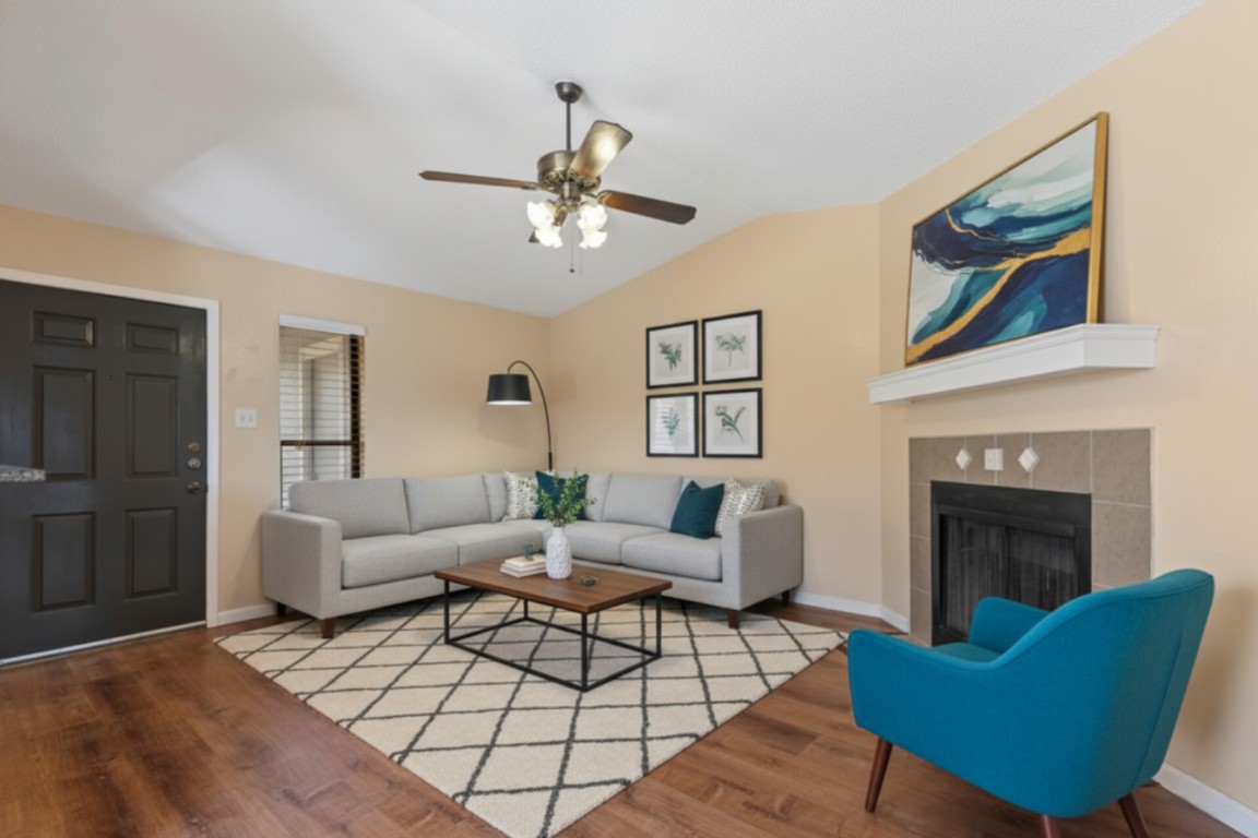 10616 Mellow Meadow Drive, Unit 21C Austin, TX 78750 - Photo 3 of 39 a living room with furniture and a fireplace