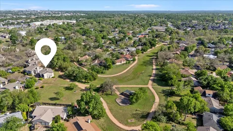 an aerial view of a house with a swimming pool