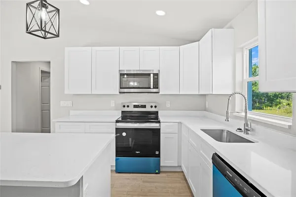 a kitchen with a sink cabinets and stainless steel appliances