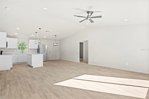 a view of an empty room and wooden floor