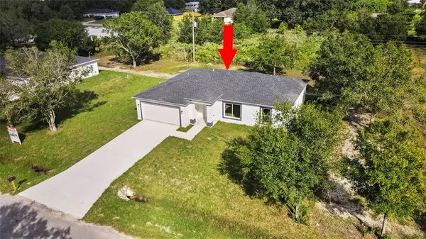 a front view of a house with a yard and fountain