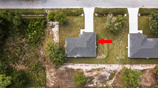 an aerial view of residential houses with outdoor space and swimming pool