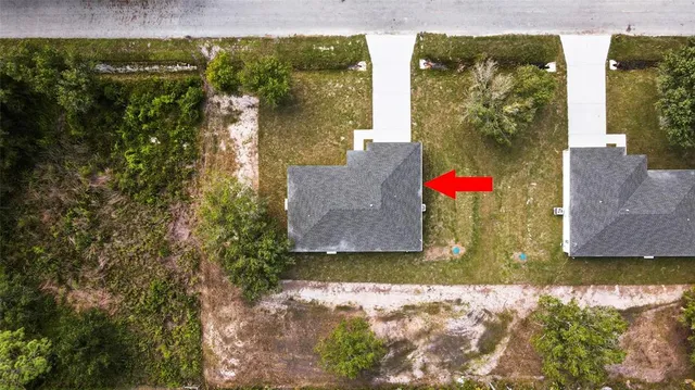 an aerial view of residential houses with outdoor space and swimming pool