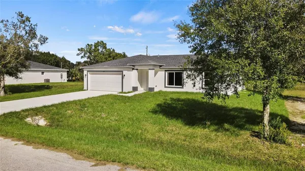 a front view of house with yard and green space