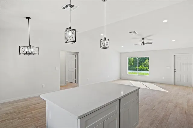 a view of a kitchen with wooden floor and window