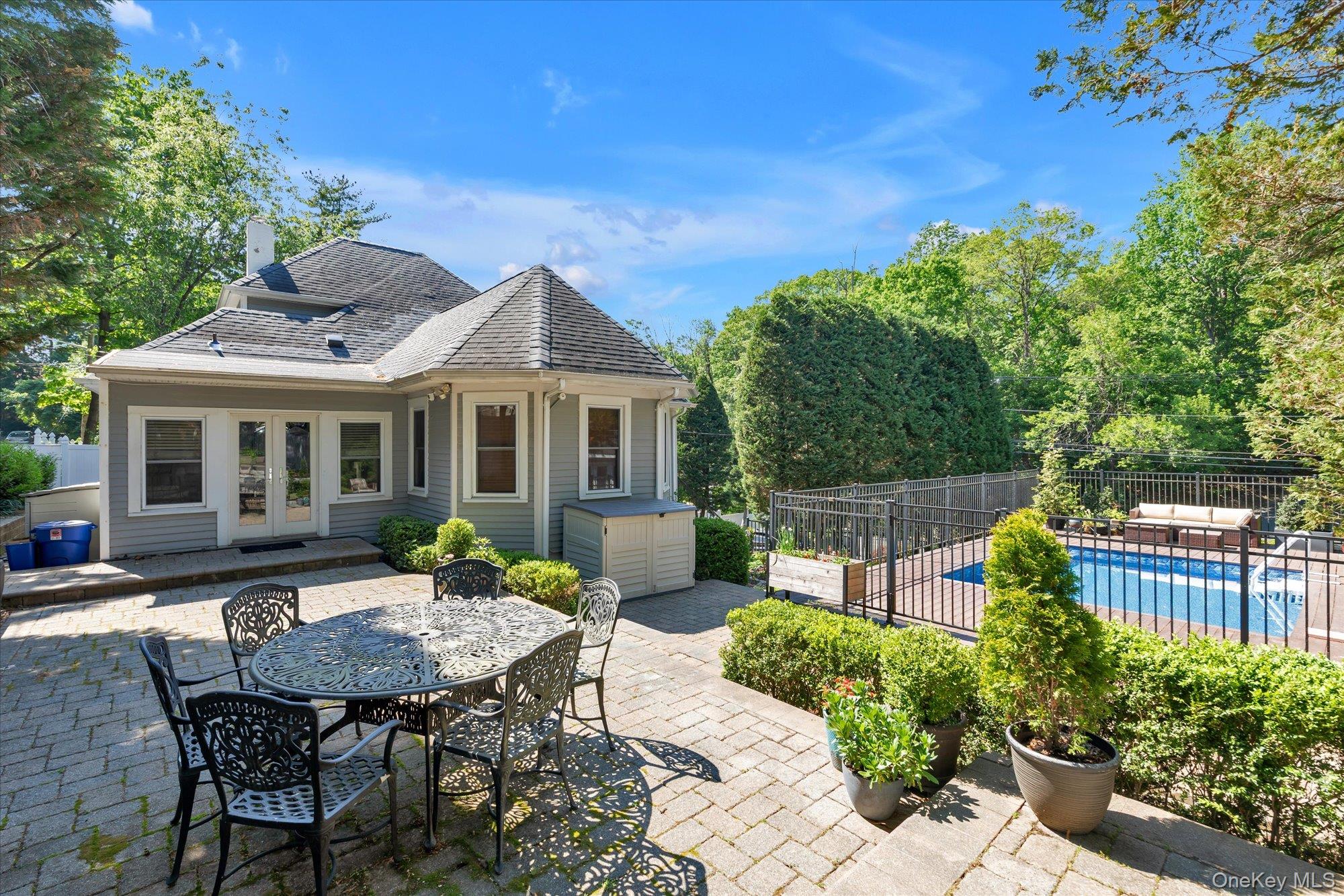 80 Skunks Misery Road Locust Valley, NY 11560 - Photo 23 of 25 a view of a house with a backyard and sitting area