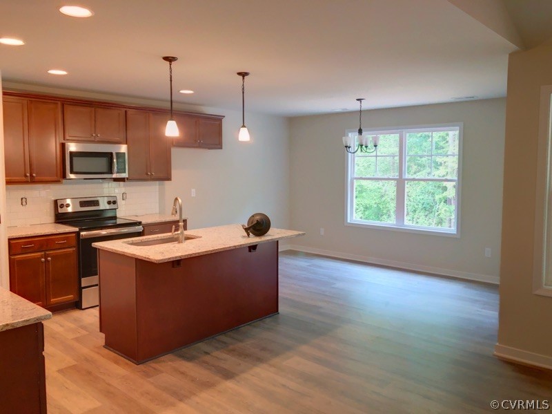 4919 Appelman Ridge Chesterfield, VA 23832 - Photo 4 of 6 a large kitchen with stainless steel appliances granite countertop a stove a sink and a wooden floors