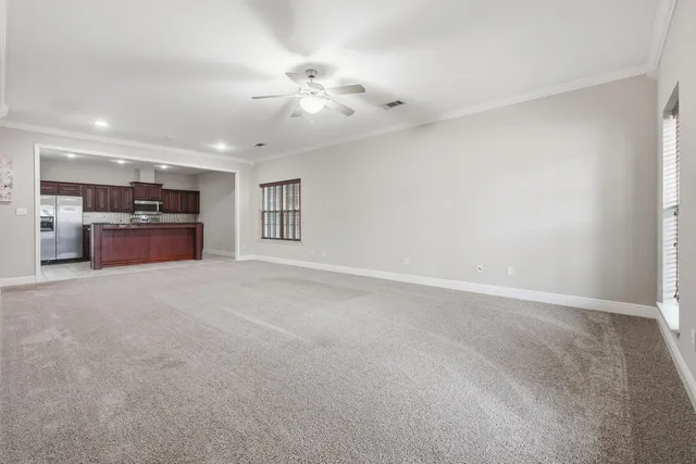 a kitchen with stainless steel appliances granite countertop a refrigerator and a stove