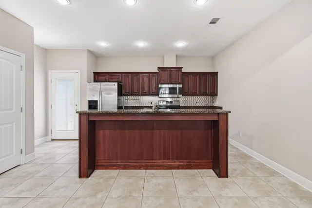 a bathroom with a granite countertop sink double and mirror