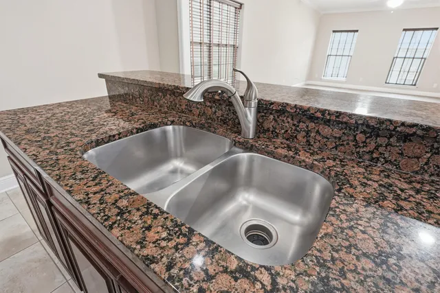 a bathroom with a granite countertop toilet a sink and a mirror