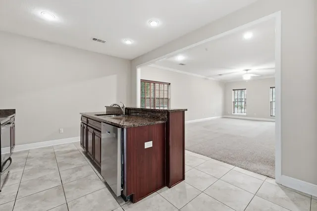 an empty room with a ceiling fan and a window