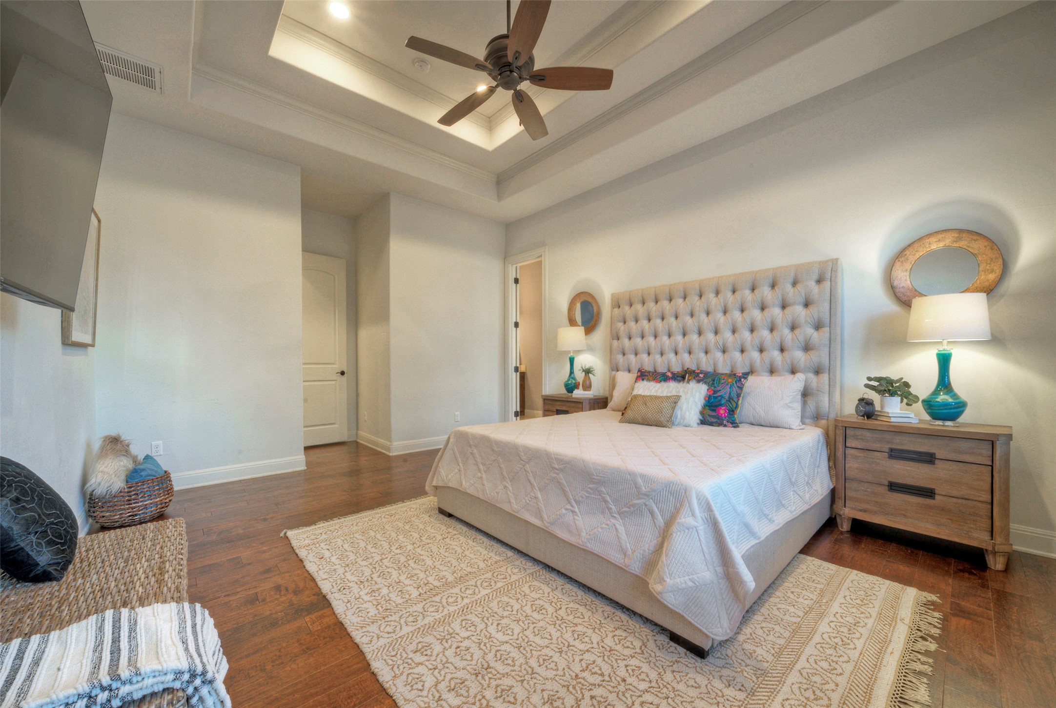7 Parkside Road The Hills, TX 78738 - Photo 15 of 36 Bedroom with ornamental molding, a tray ceiling, dark wood-style floors, and a ceiling fan