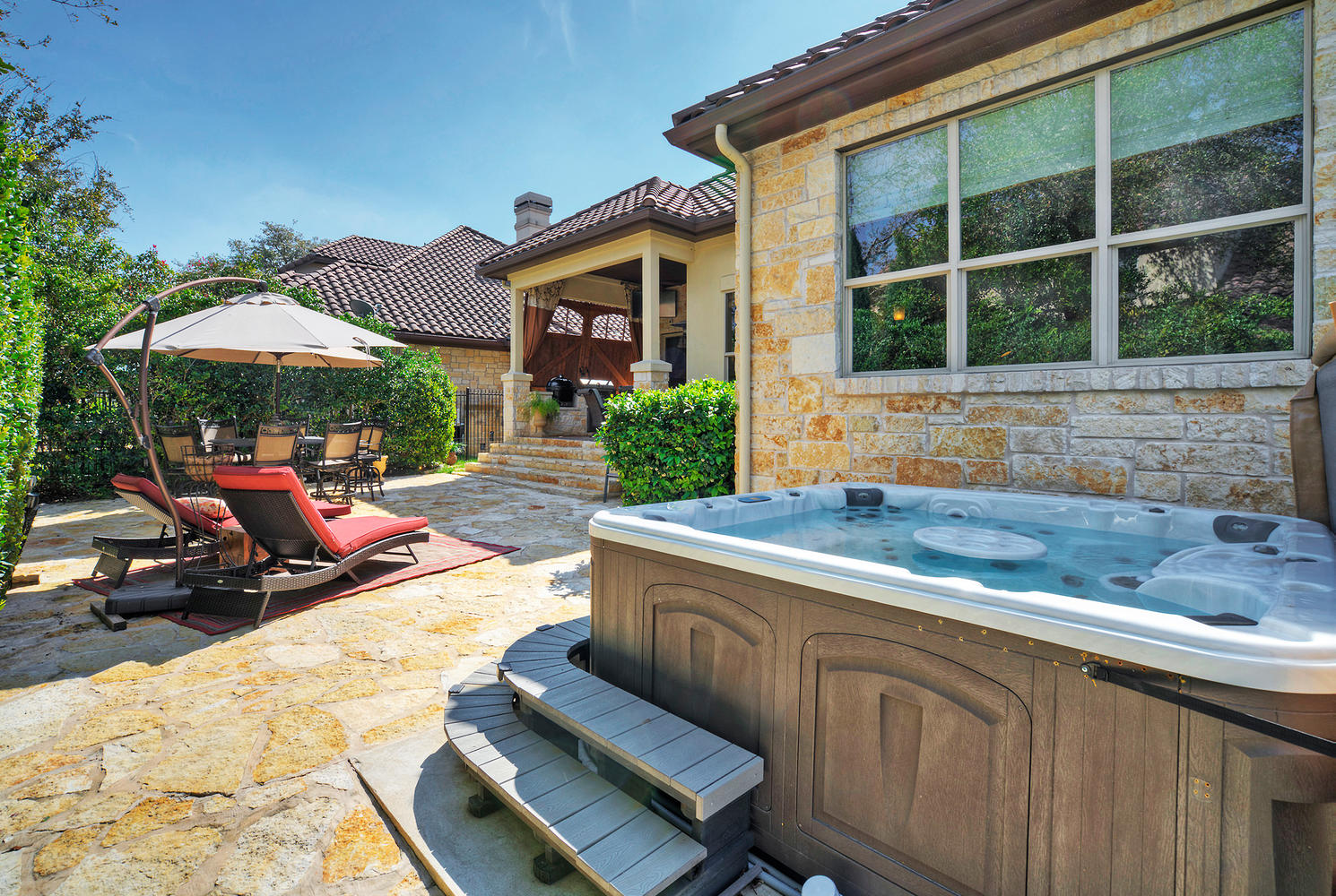 7 Parkside Road The Hills, TX 78738 - Photo 35 of 36 View of patio / terrace featuring a hot tub, a gazebo, and outdoor dining space