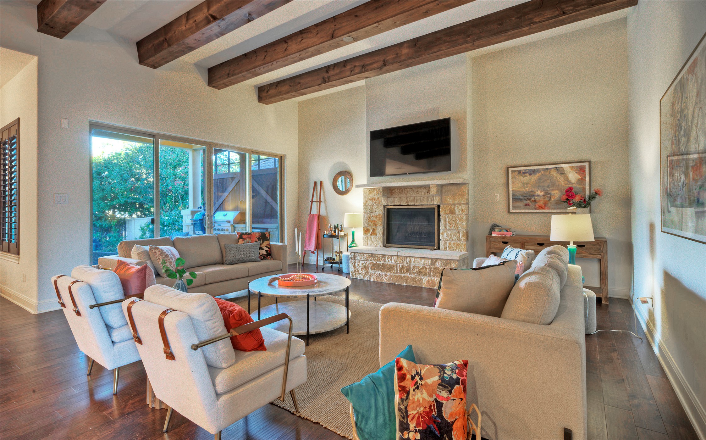 7 Parkside Road The Hills, TX 78738 - Photo 4 of 36 Living room featuring a fireplace, beam ceiling, and dark wood-style flooring