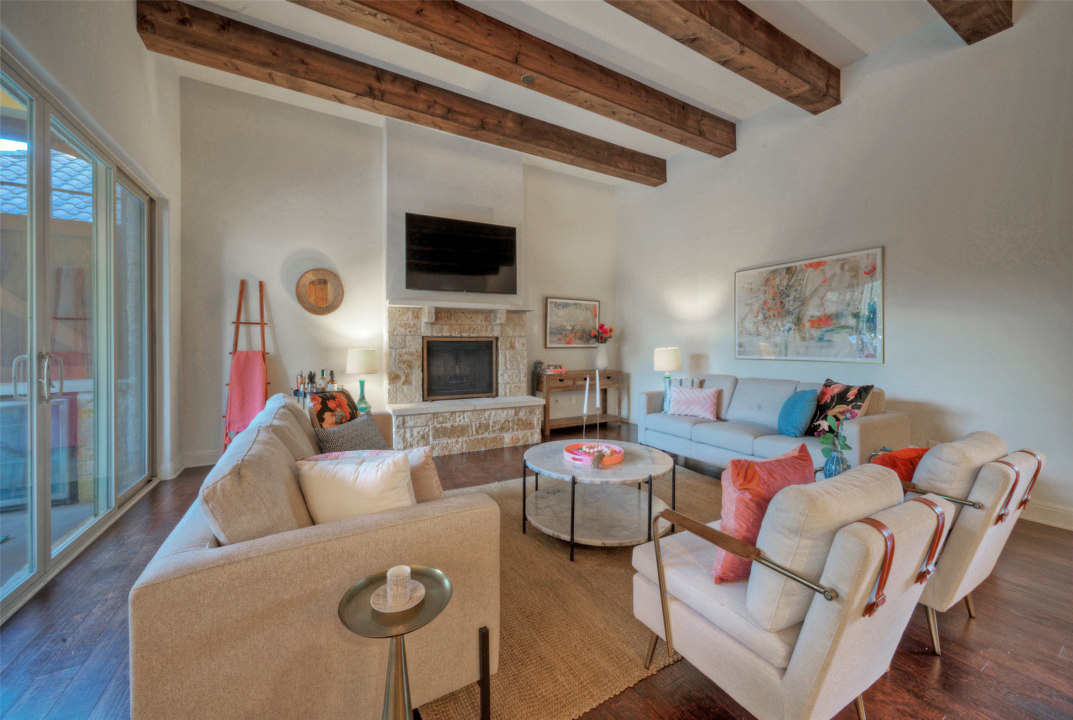 7 Parkside Road The Hills, TX 78738 - Photo 5 of 36 Living area with beam ceiling, wood finished floors, and a fireplace