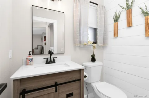 a bathroom with a sink a toilet and mirror