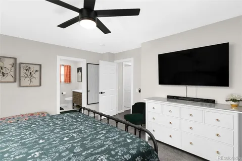 a bedroom with a bed and a flat screen tv