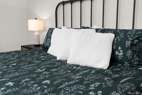 a bed sitting in a bedroom next to a window