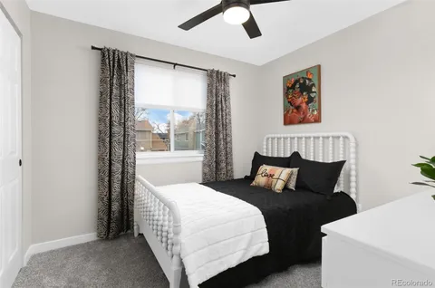 a view of a bedroom with wooden floor and a bed