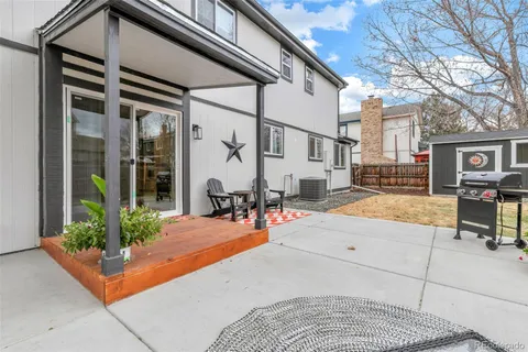 a view of a patio with table and chairs and potted plants