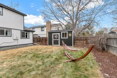a view of a backyard with table and chairs