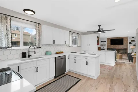 a kitchen with stainless steel appliances granite countertop a sink and cabinets
