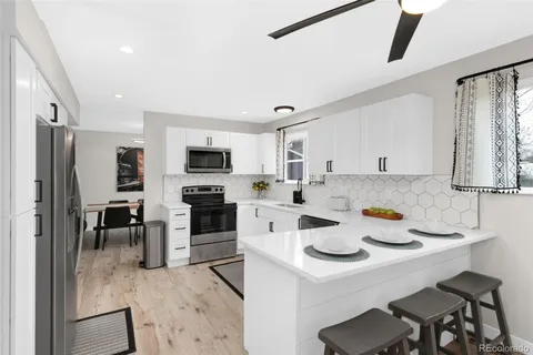 a kitchen with a sink microwave and refrigerator