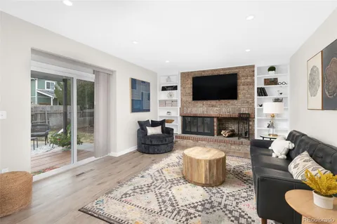 a living room with furniture a flat screen tv and a fireplace