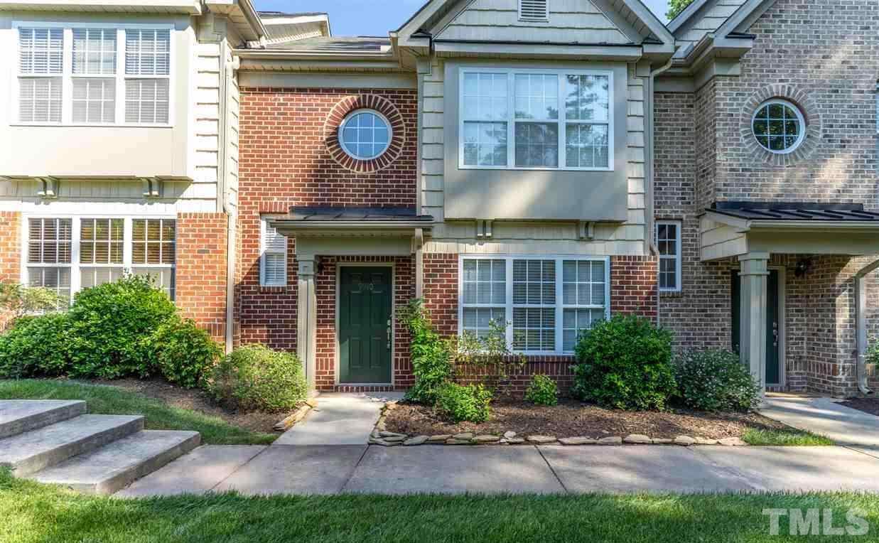 9910 Layla Avenue Raleigh, NC 27617 - Photo 1 of 13 a front view of a house with garden