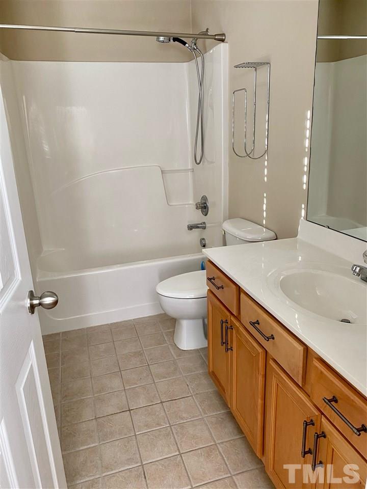 9910 Layla Avenue Raleigh, NC 27617 - Photo 12 of 13 a bathroom with a sink a toilet and shower