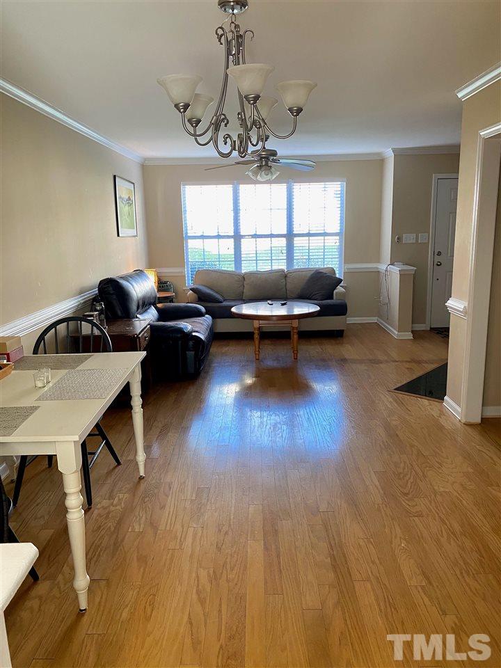 9910 Layla Avenue Raleigh, NC 27617 - Photo 3 of 13 a living room with furniture and a wooden floor