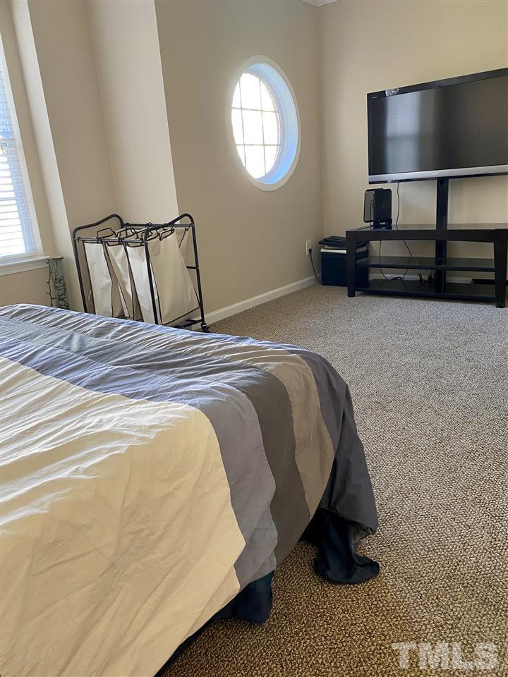 9910 Layla Avenue Raleigh, NC 27617 - Photo 9 of 13 a bedroom with a bed and window