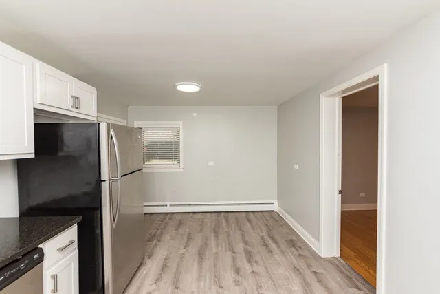 a kitchen with a refrigerator and a stove top oven