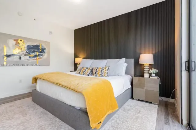 a bed room with a bed and a night stand