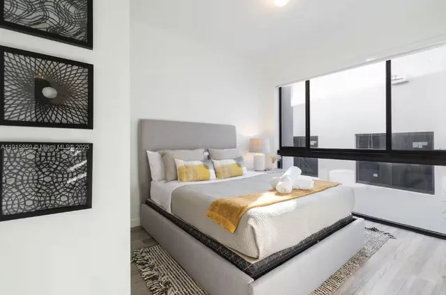 a bedroom with a bed and a night stand