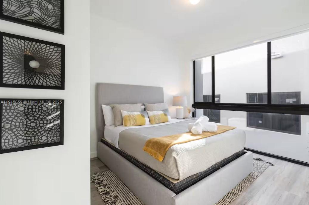 2955 Bird Avenue, Unit PHB Miami, FL 33133 - Photo 15 of 23 a bedroom with a bed and a night stand