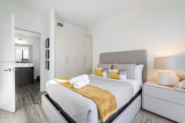 a bedroom with a bed and a lamp