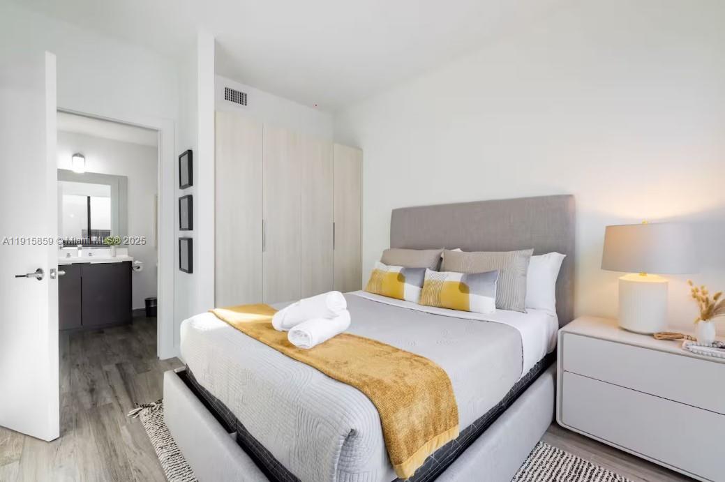 2955 Bird Avenue, Unit PHB Miami, FL 33133 - Photo 16 of 23 a bedroom with a bed and a lamp