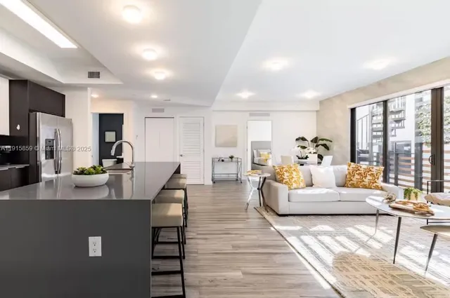 a living room with furniture and a large window